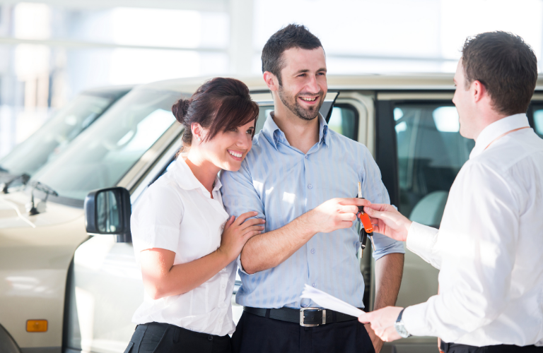 A couple taking keys of their vehicle 