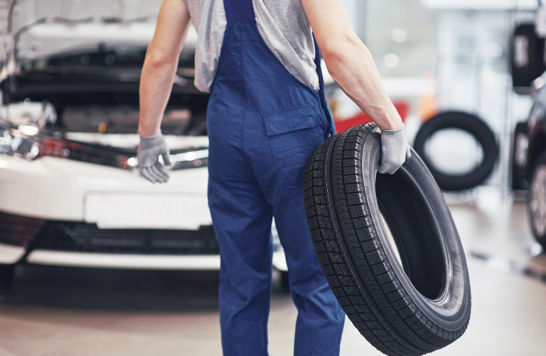 Mechanic carrying tire