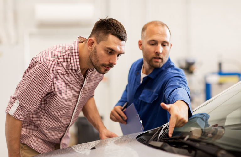 Mechanic and a customer at a service station